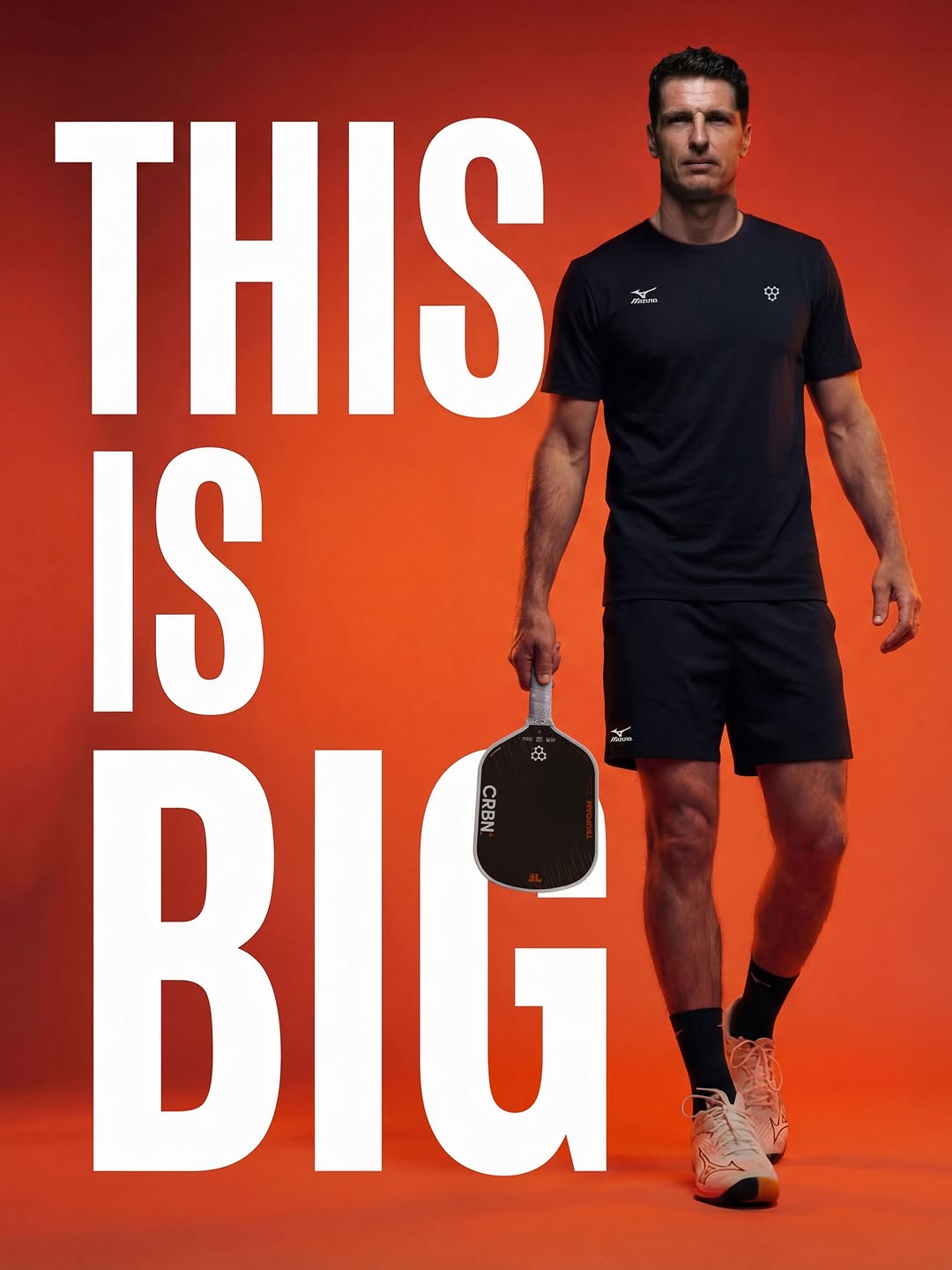 Andrei Daescu holding a CRBN paddle in front of an orange background with the words This Is Big