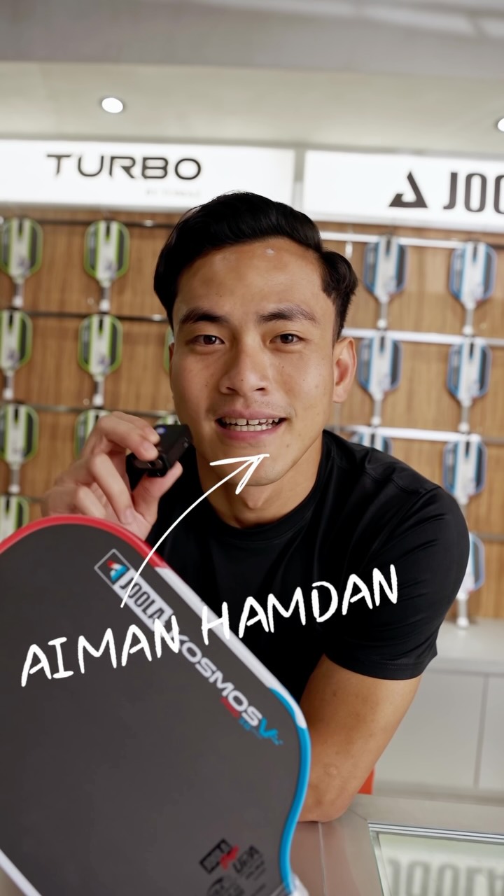 Aiman Hamdan holding a JOOLA paddle at the Tomaz Pickleball Club store