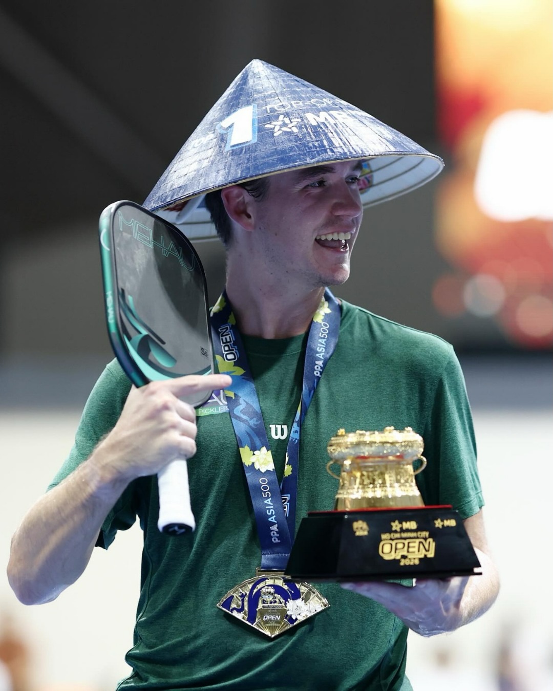 Adam Harvey holding his MEHAU paddle and PPA Asia 500 MB Ho Chi Minh City Open trophy