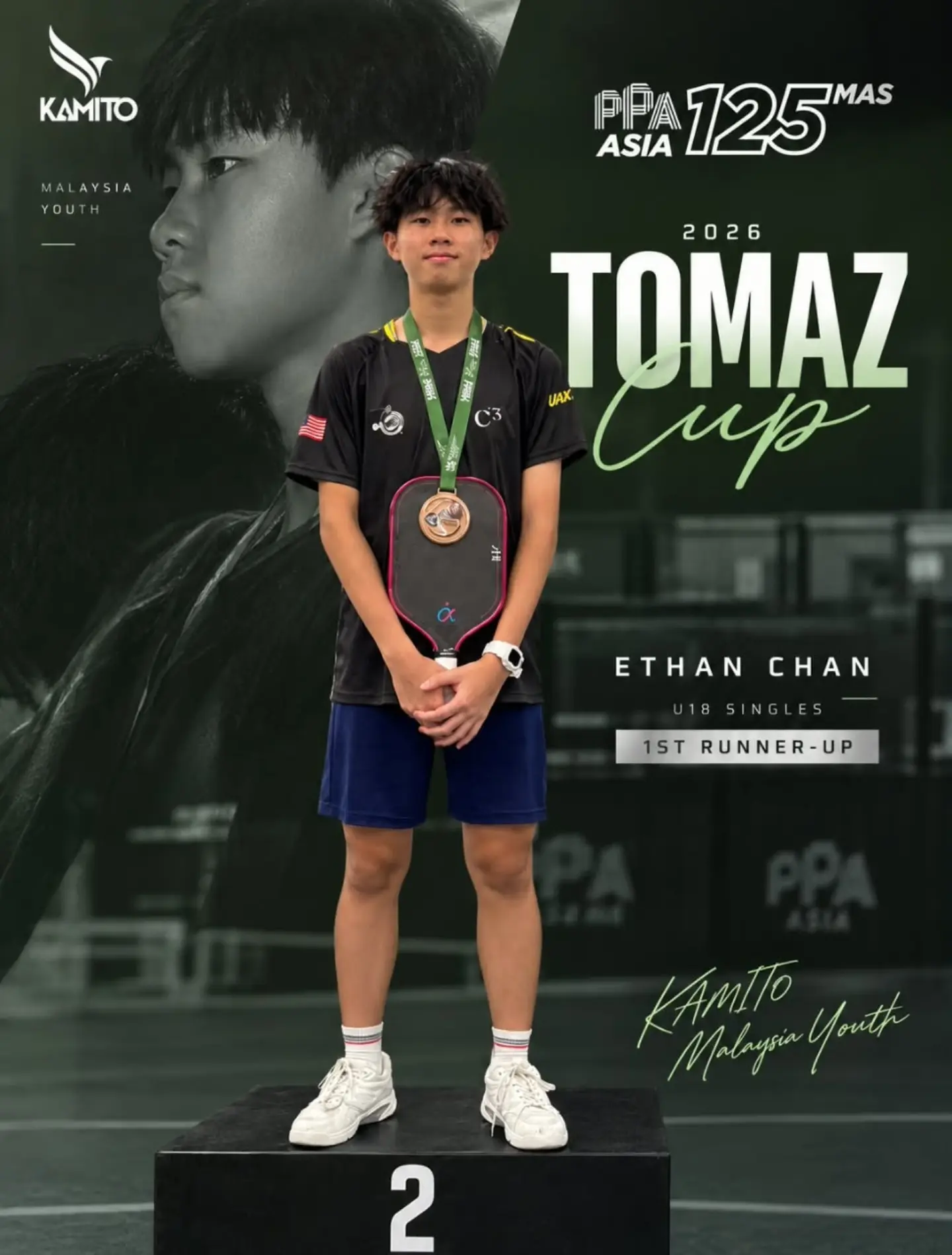 Ethan Chan stands on the second-place podium block with his silver medal after the U18 Singles final at the 2026 Tomaz Cup