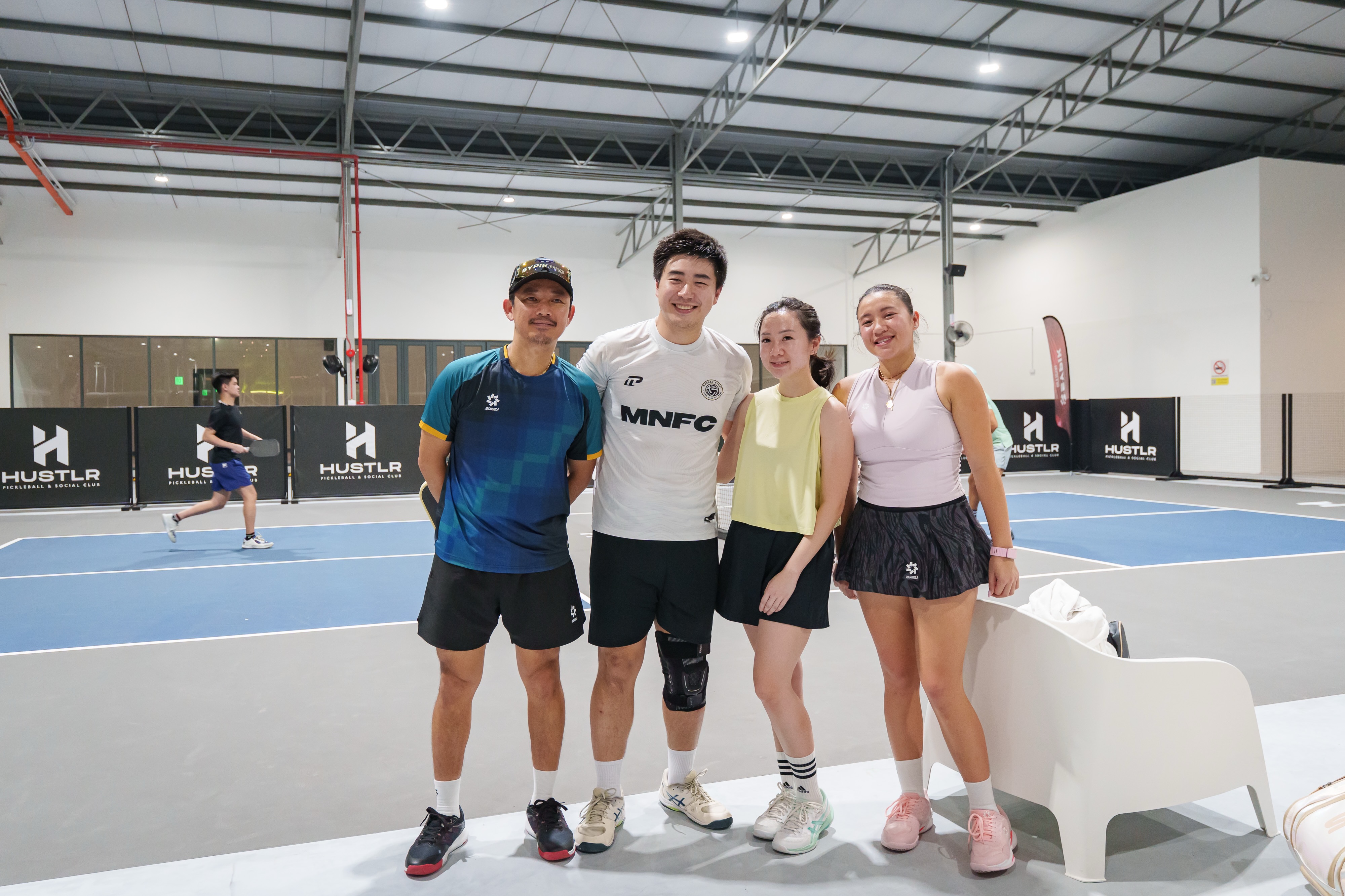 Sypik players and community members pose together at Hustlr