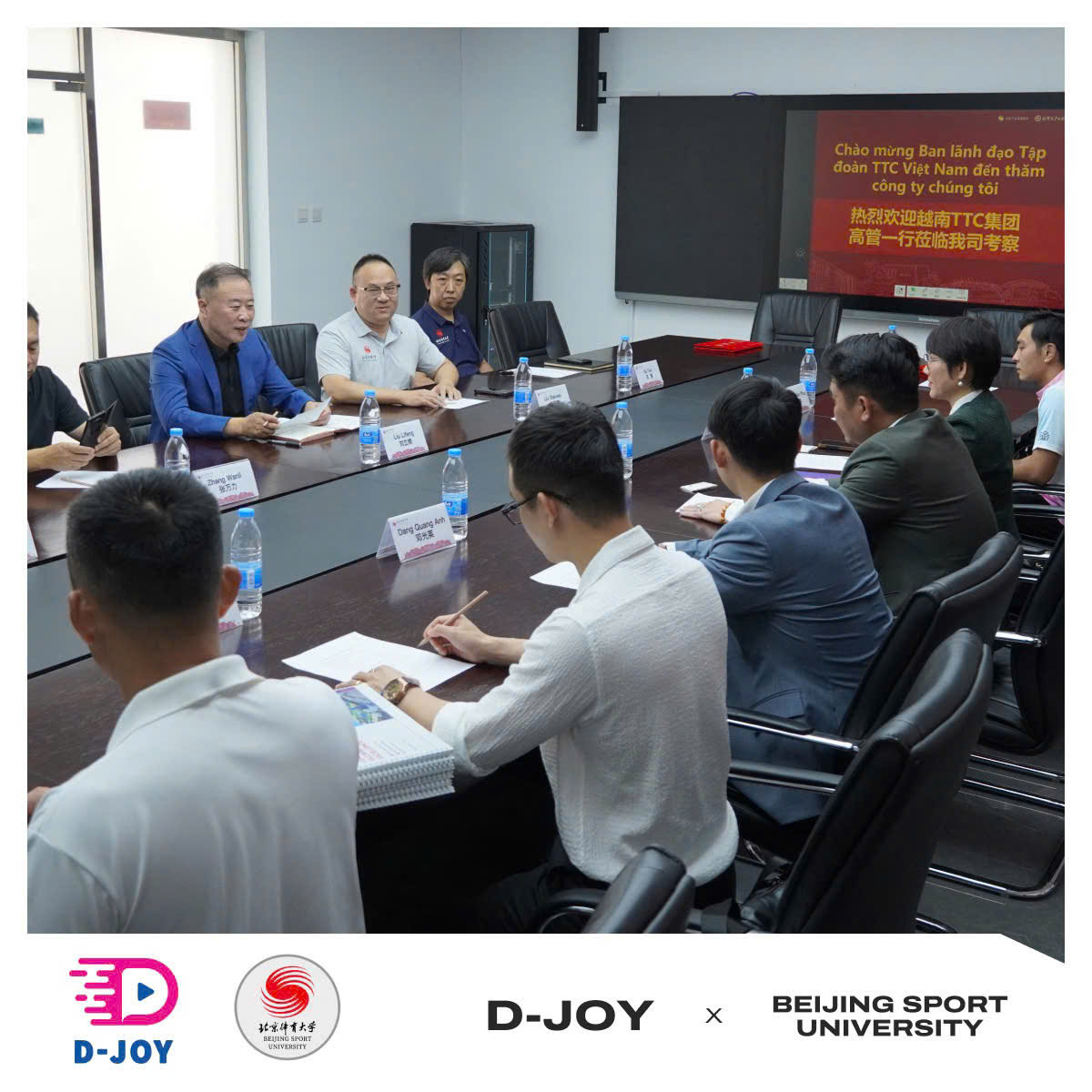 The D-Joy and Beijing Sport University delegations meeting around a conference table in Beijing.