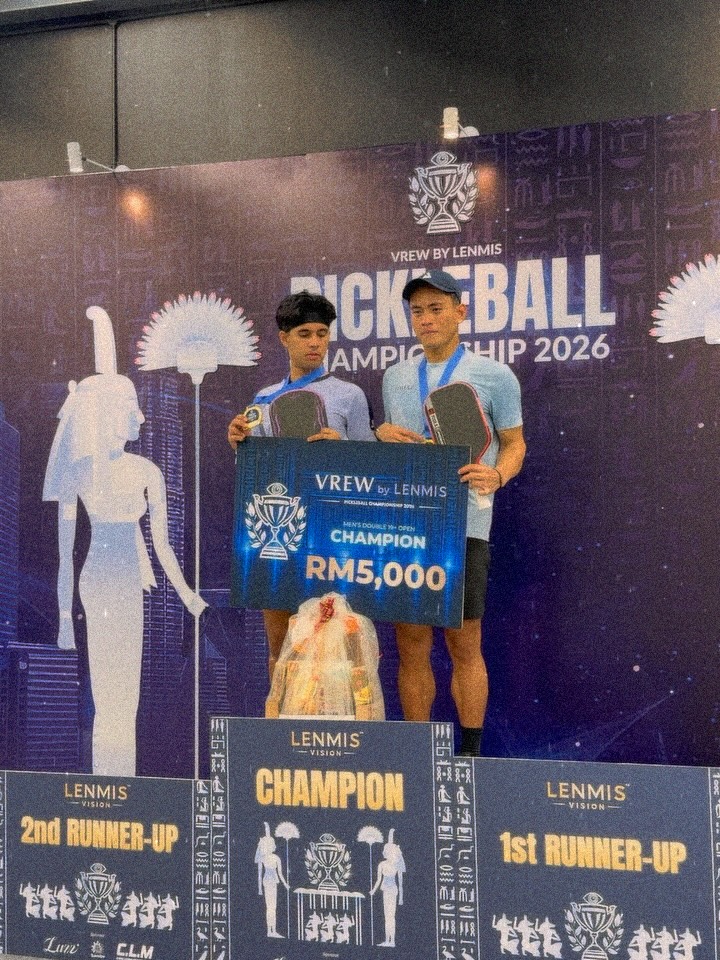 Syed Uzair and Aaiman Hamdan on the winners' podium at the VREW by Lenmis Pickleball Championship 2026, holding a champion board reading RM5,000