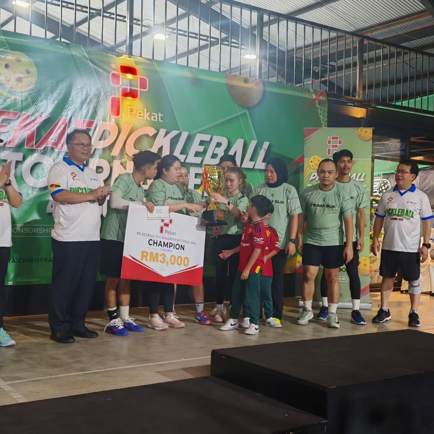 Team SUK receiving the champion trophy and a RM3,000 prize board at the PEKAT Pickleball Tournament