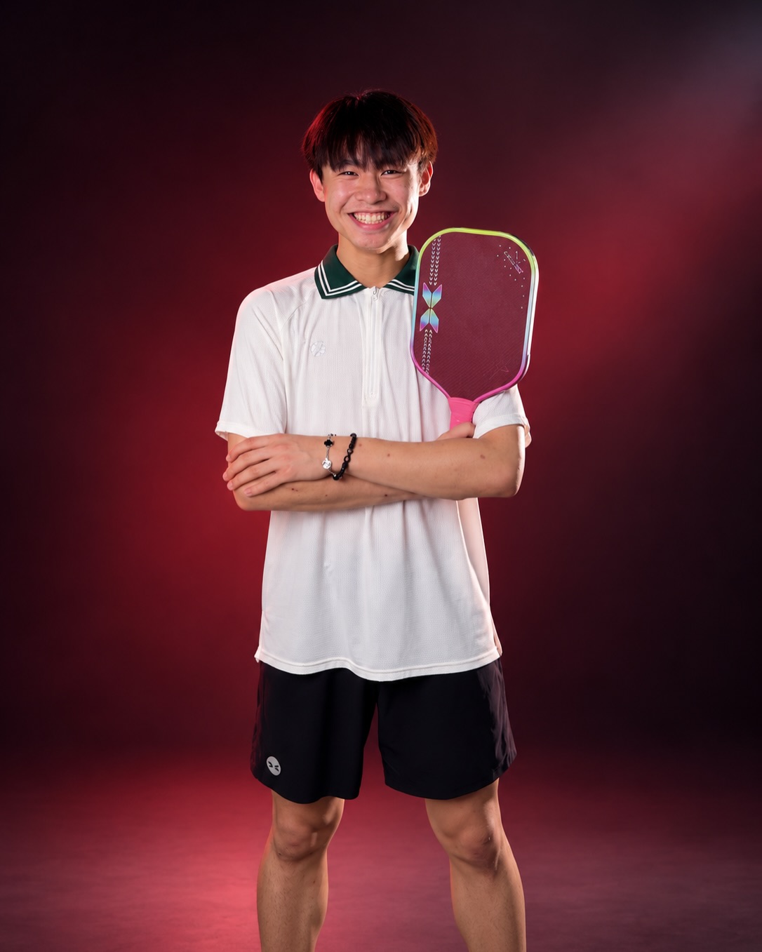 Yihern in a studio portrait holding an Arronax paddle