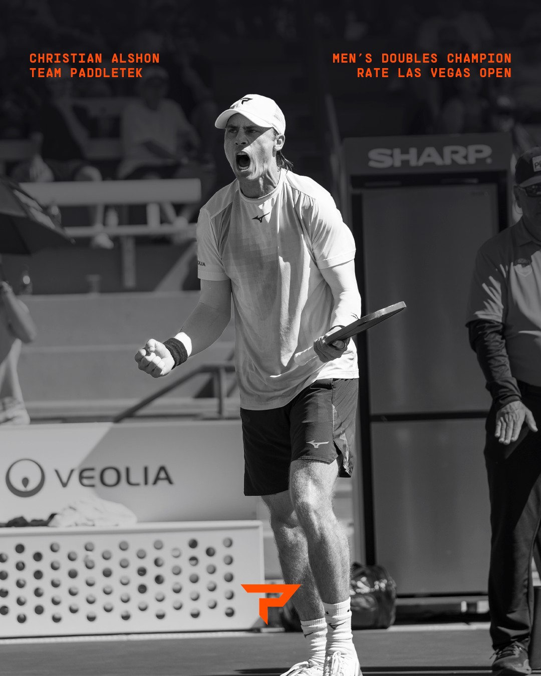 Christian Alshon roaring and pumping his fist in a black and white Team Paddletek graphic that reads Men's Doubles Champion, Rate Las Vegas Open