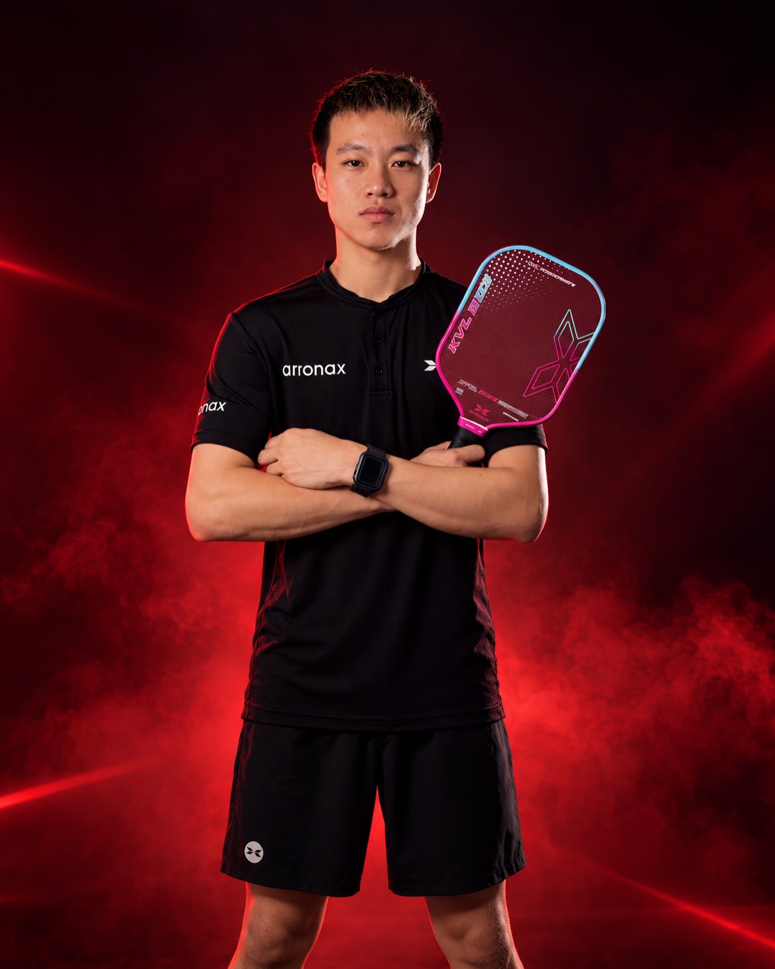 Lagger Chan in Arronax apparel holding an Arronax paddle