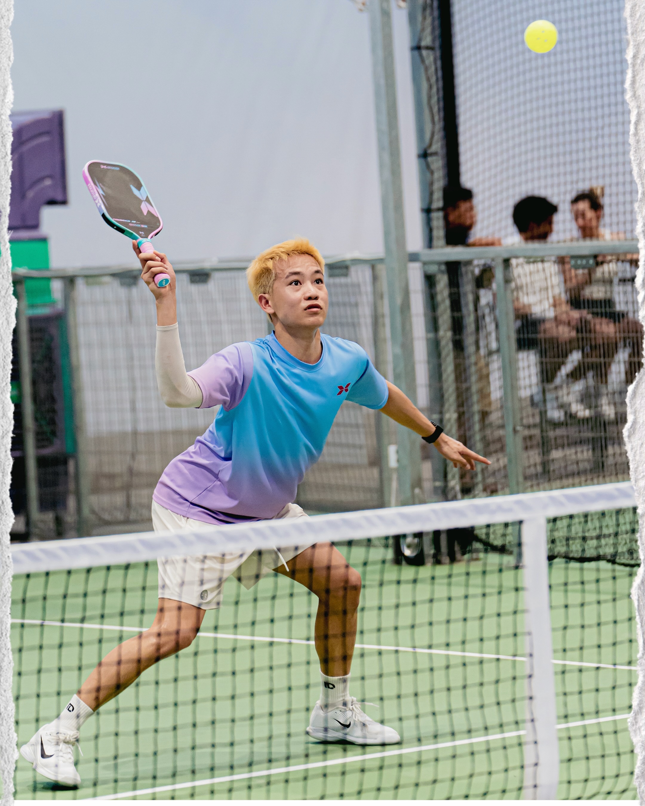Lagger Chan playing at the net in a blue shirt