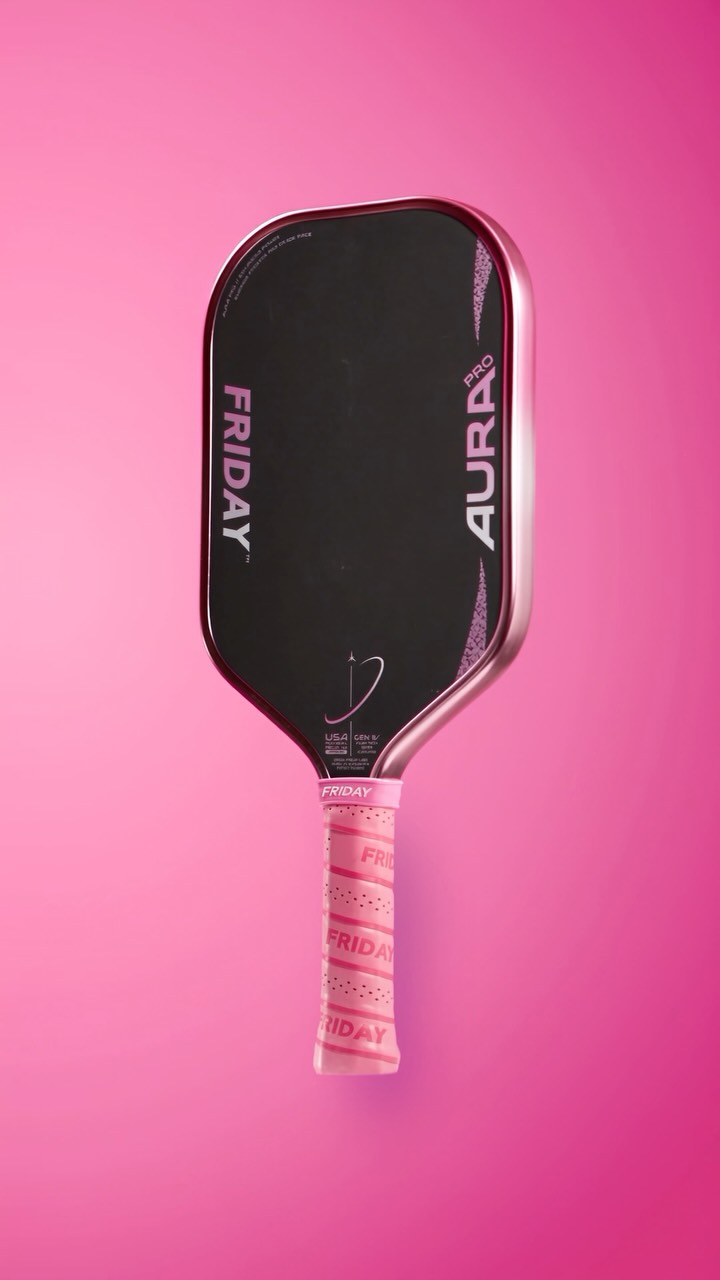 The Friday Aura Pro Metallic Pink Prism paddle against a pink background.