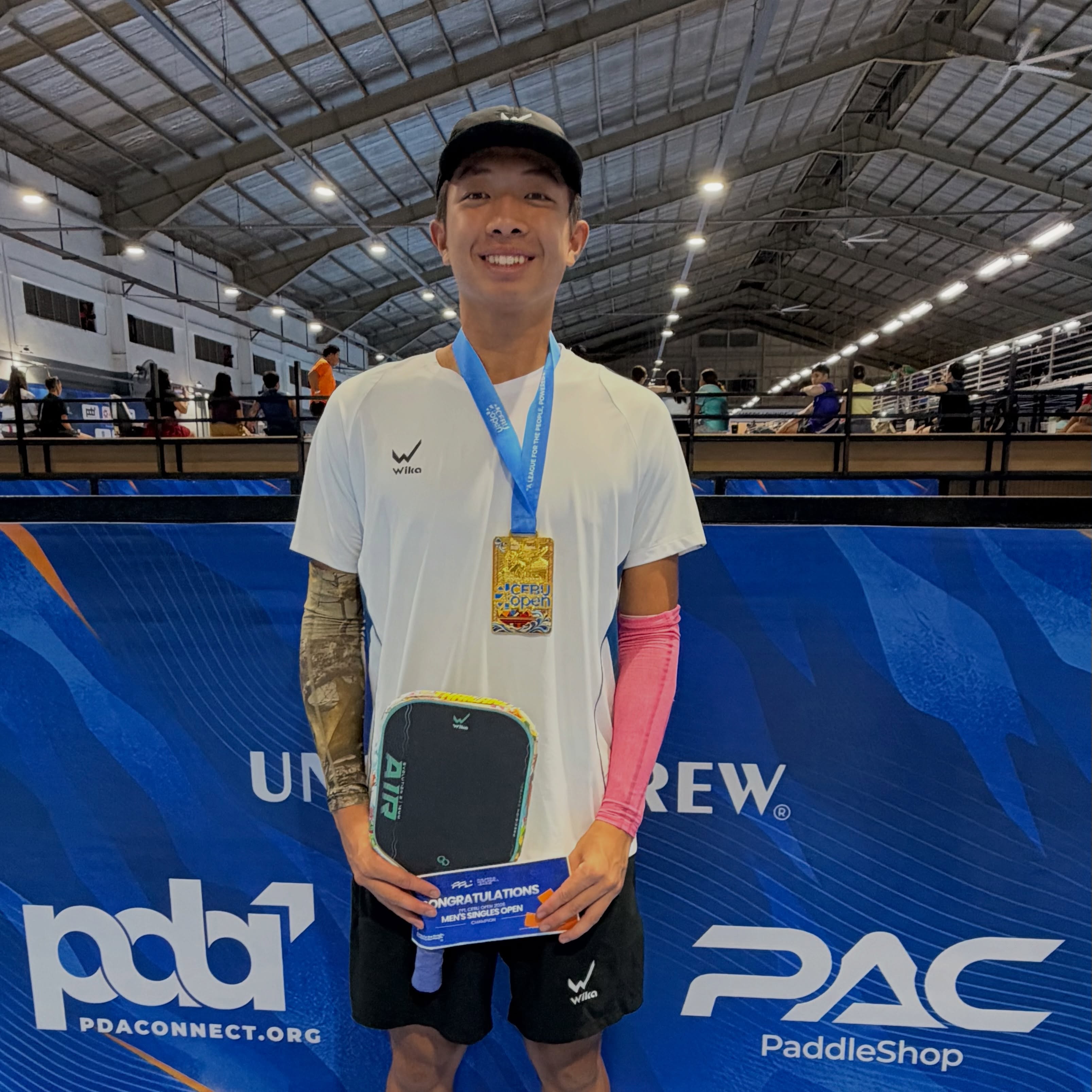 Quang Duong with his Cebu Open gold medal and Men's Singles Open champion certificate