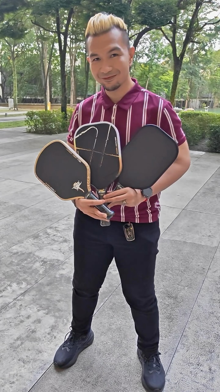 PicklePlayCo coach holding three paddles in the cover frame of the unboxing reel