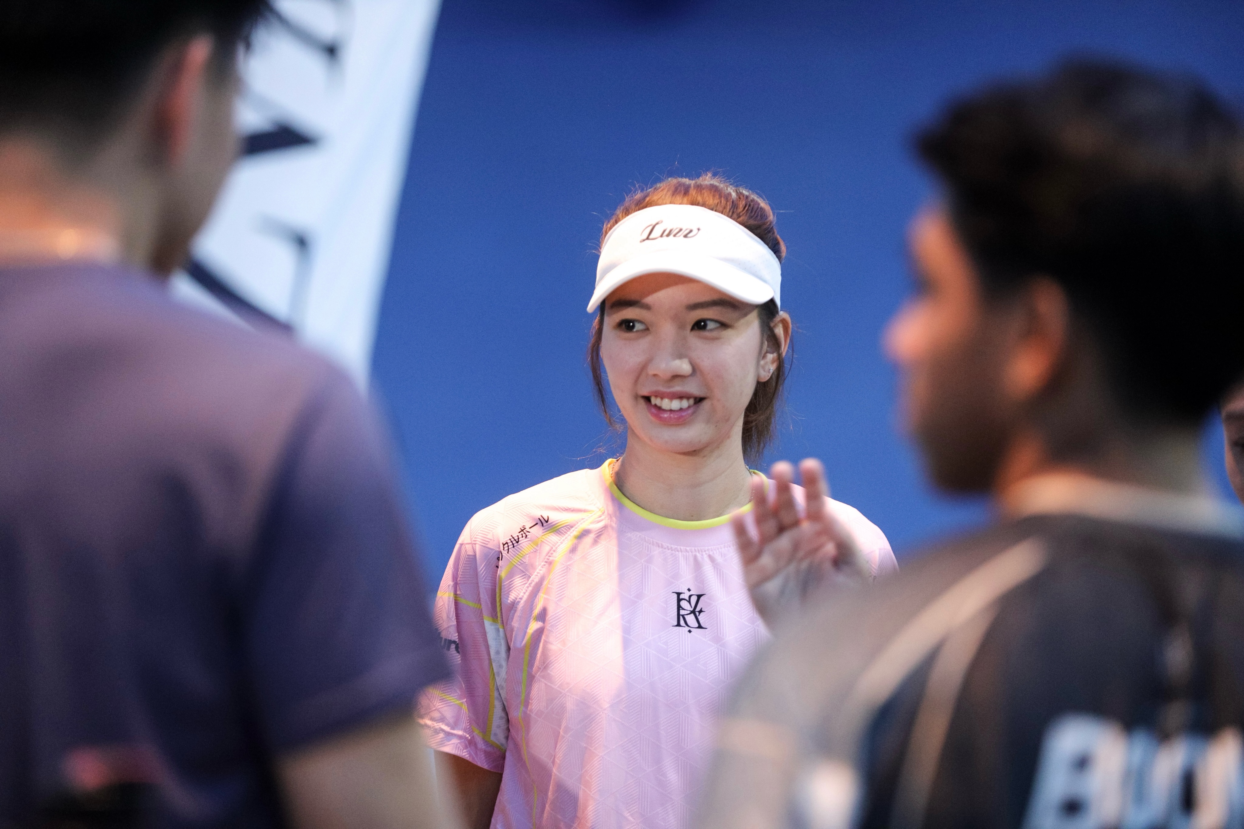 Sabrina Gee smiling at the event in a Luzz visor