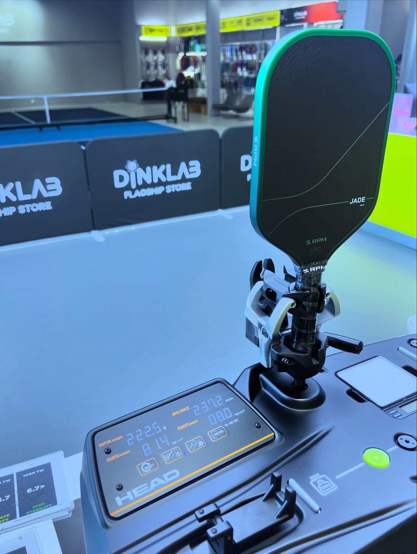 An RPM Jade paddle clamped in a HEAD measuring device at the DINKLAB Flagship Store