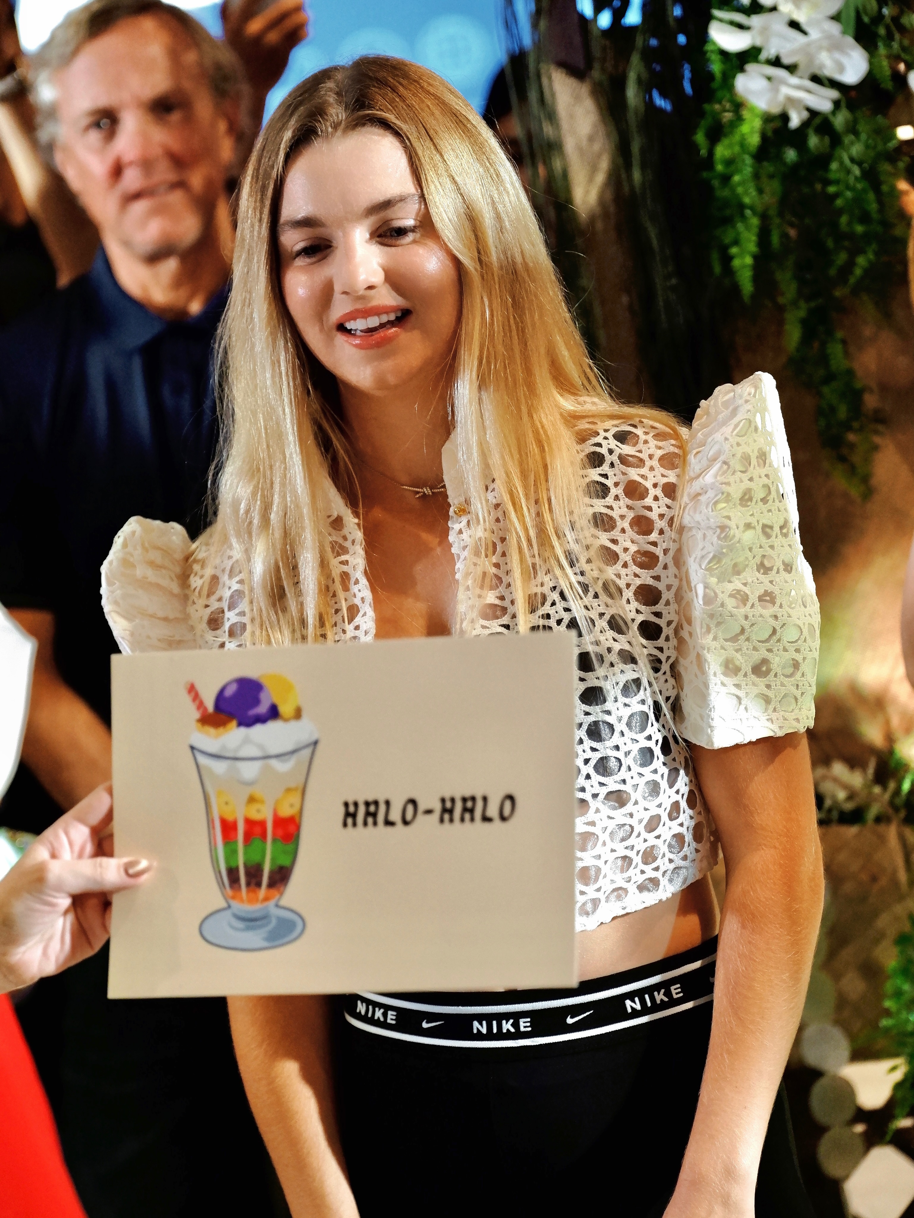 Anna Leigh Waters holding a halo-halo card at Chris Sports