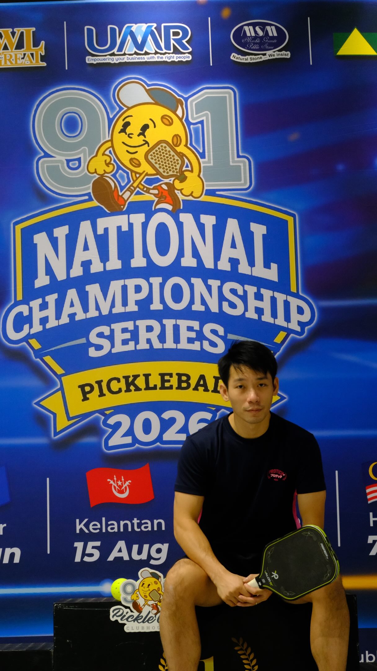 Peng Soon seated in front of the 91 National Championship Series Pickleball 2026 banner