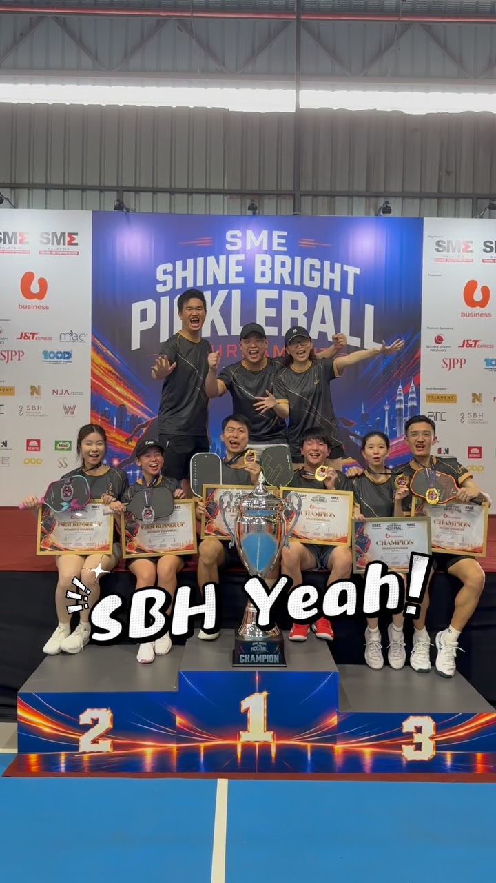 The team celebrating on the podium with certificates, medals and the trophy