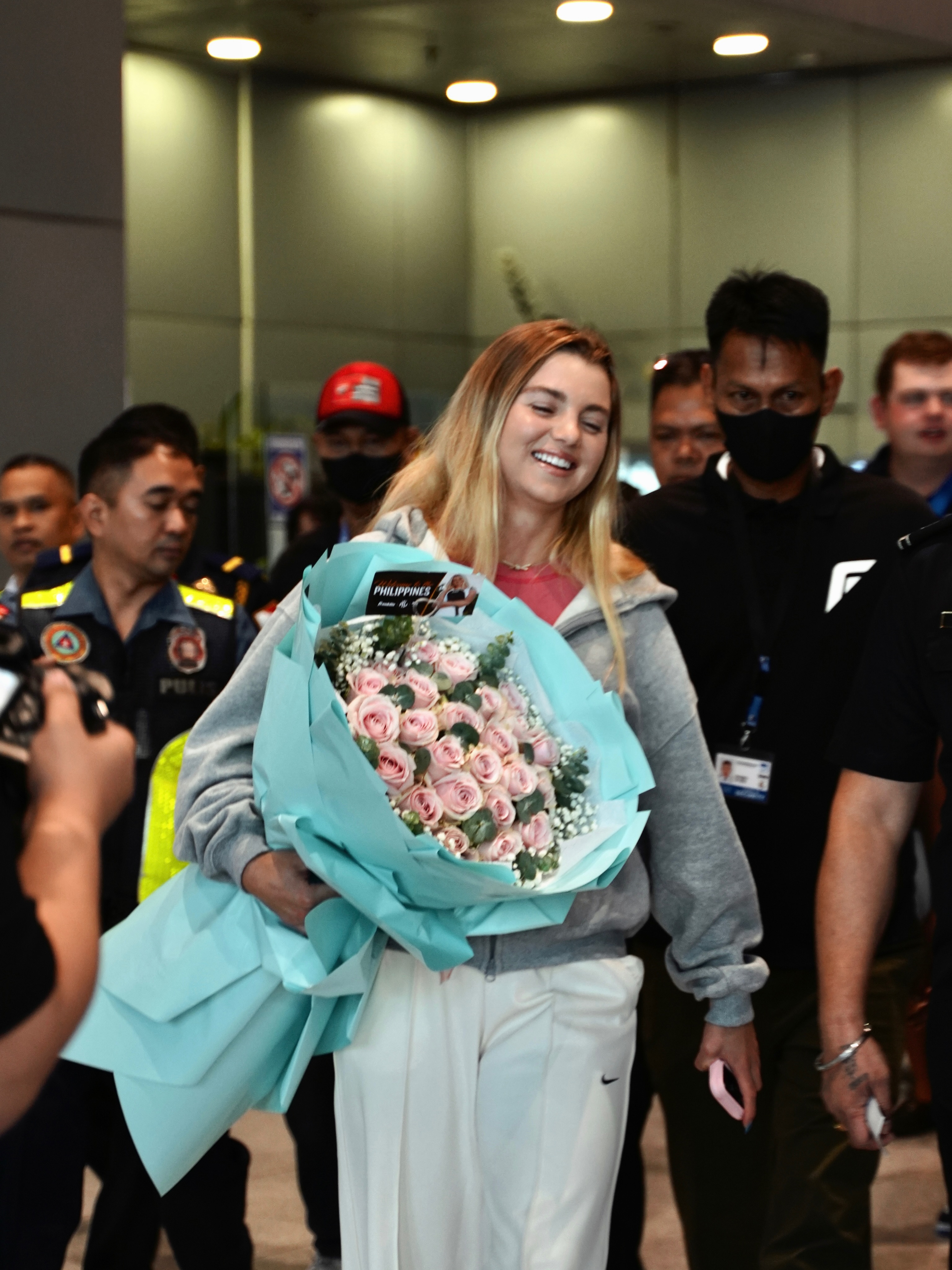 Anna Leigh Waters arriving at NAIA, Manila with a bouquet of pink roses
