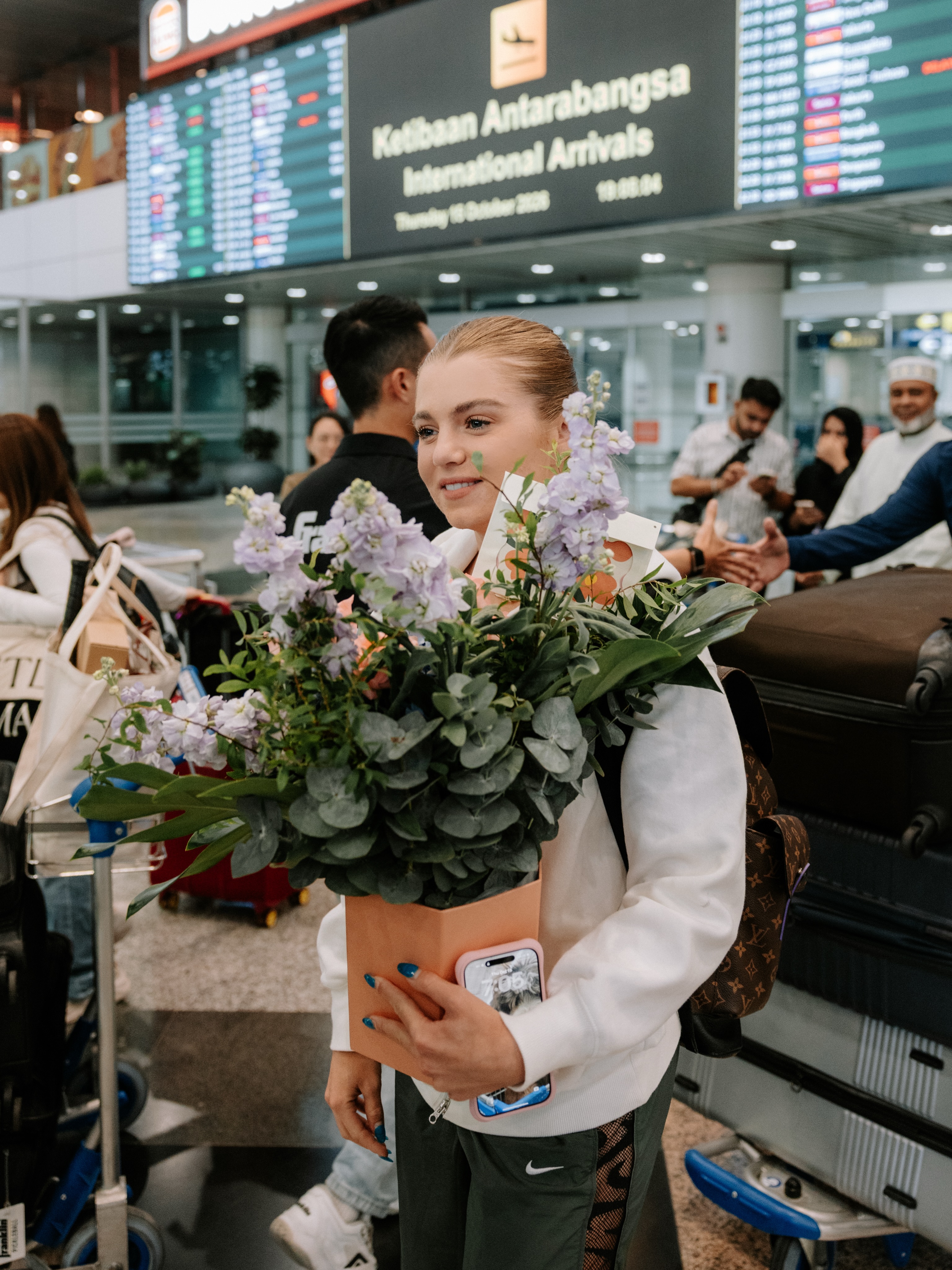 Anna Leigh Waters, arriving with flowers at international arrivals in Malaysia on 15 Oct