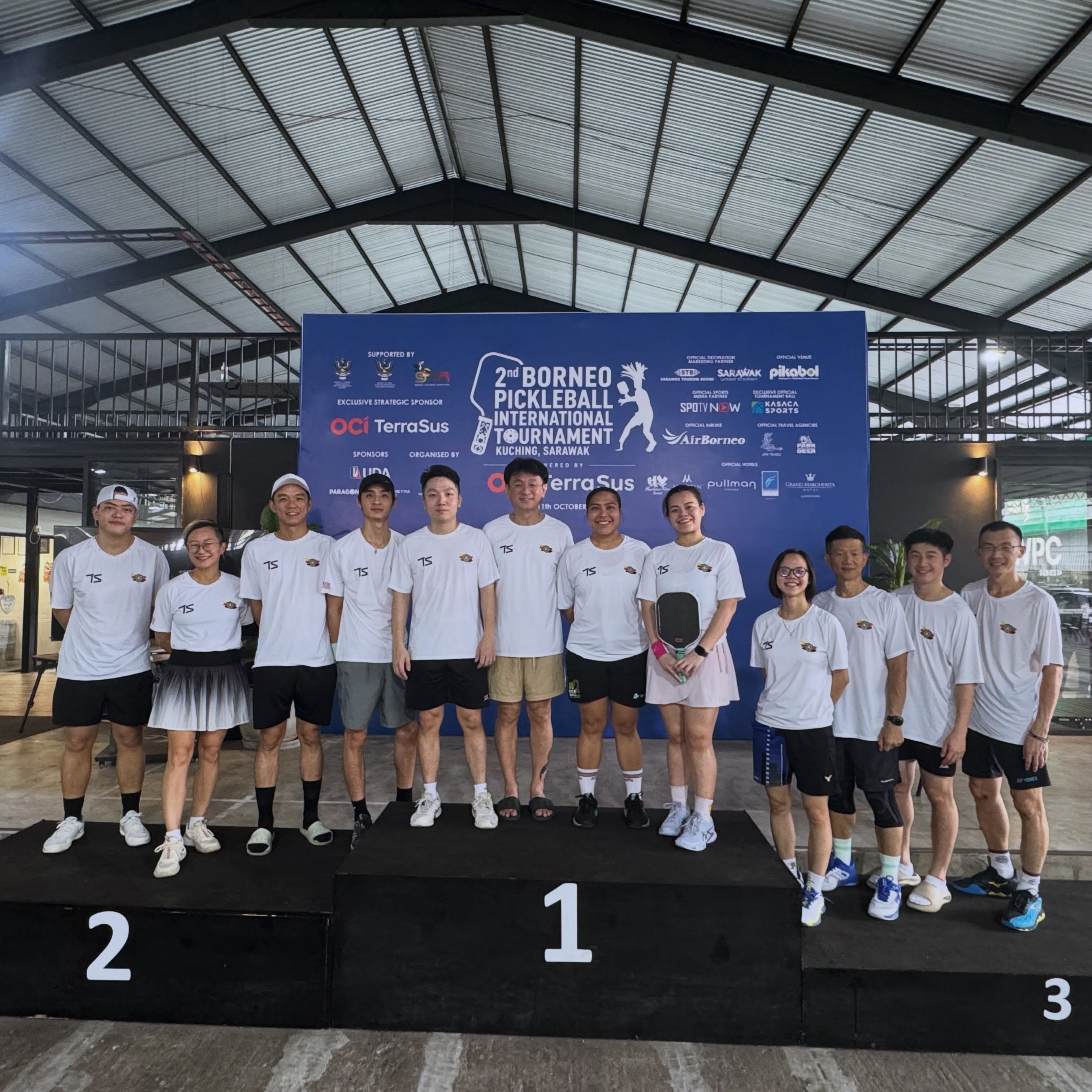 Podium in front of the 2nd Borneo Pickleball International Tournament backdrop listing sponsors including Kasaca Sports