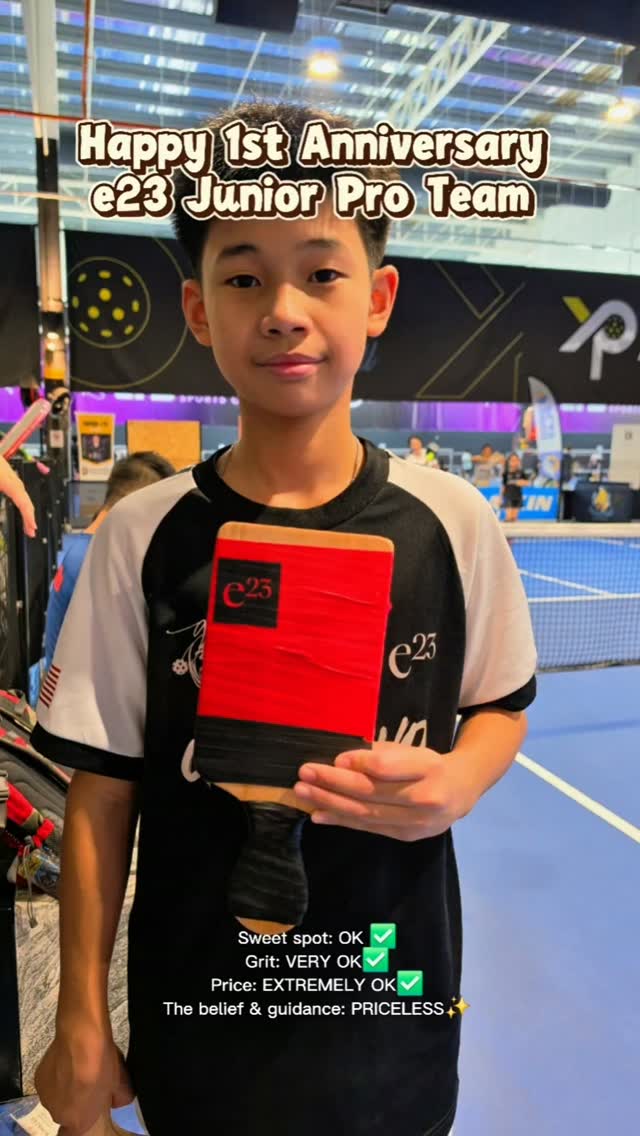 Elton Liew, holding a red e23 paddle in a clip marking one year on the e23 Junior Pro Team