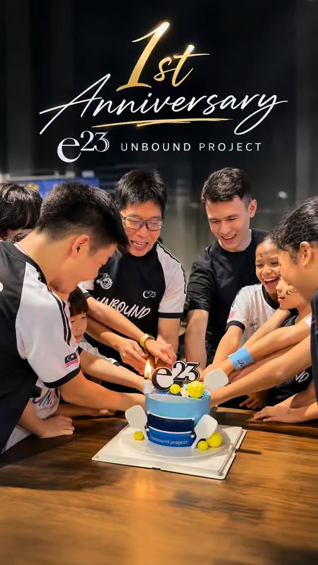 The e23 Unbound Project 1st anniversary cake, cut by a group of players and coaches