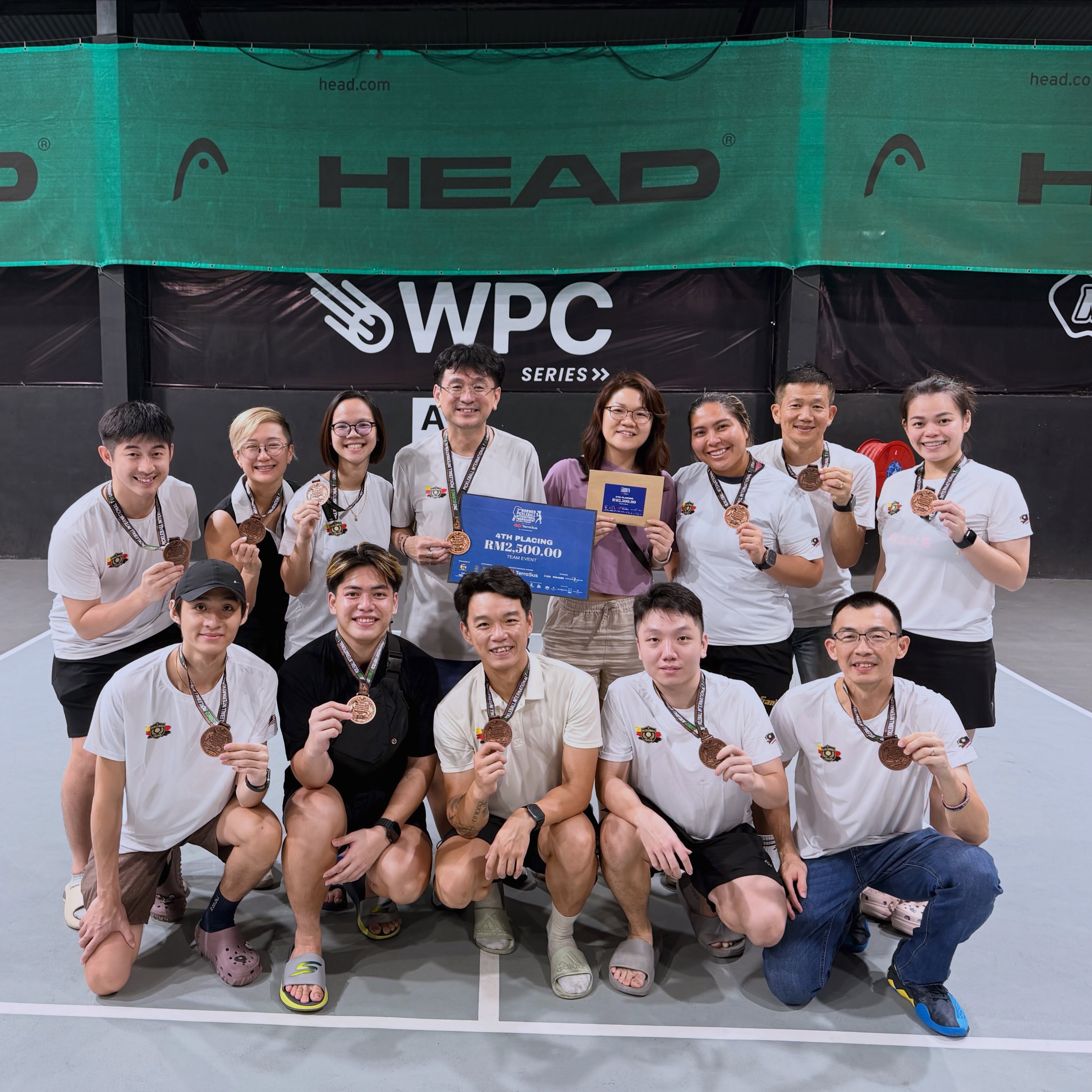 Pickleball Freak team holding medals and a 4th Placing RM2,500.00 Team Event certificate