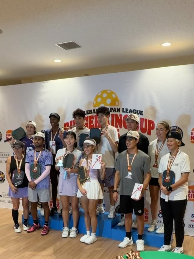A group of players on a podium under the Burger King Cup banner