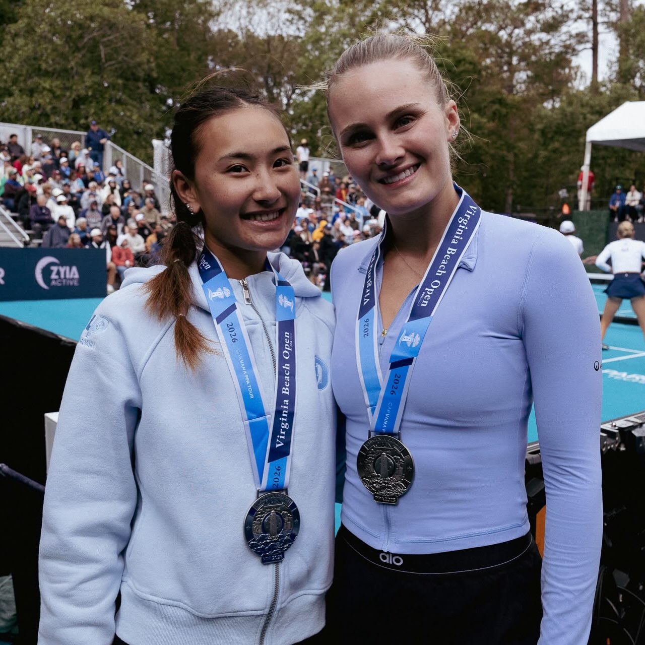 Alix Truong and her doubles partner wearing Virginia Beach Open silver medals