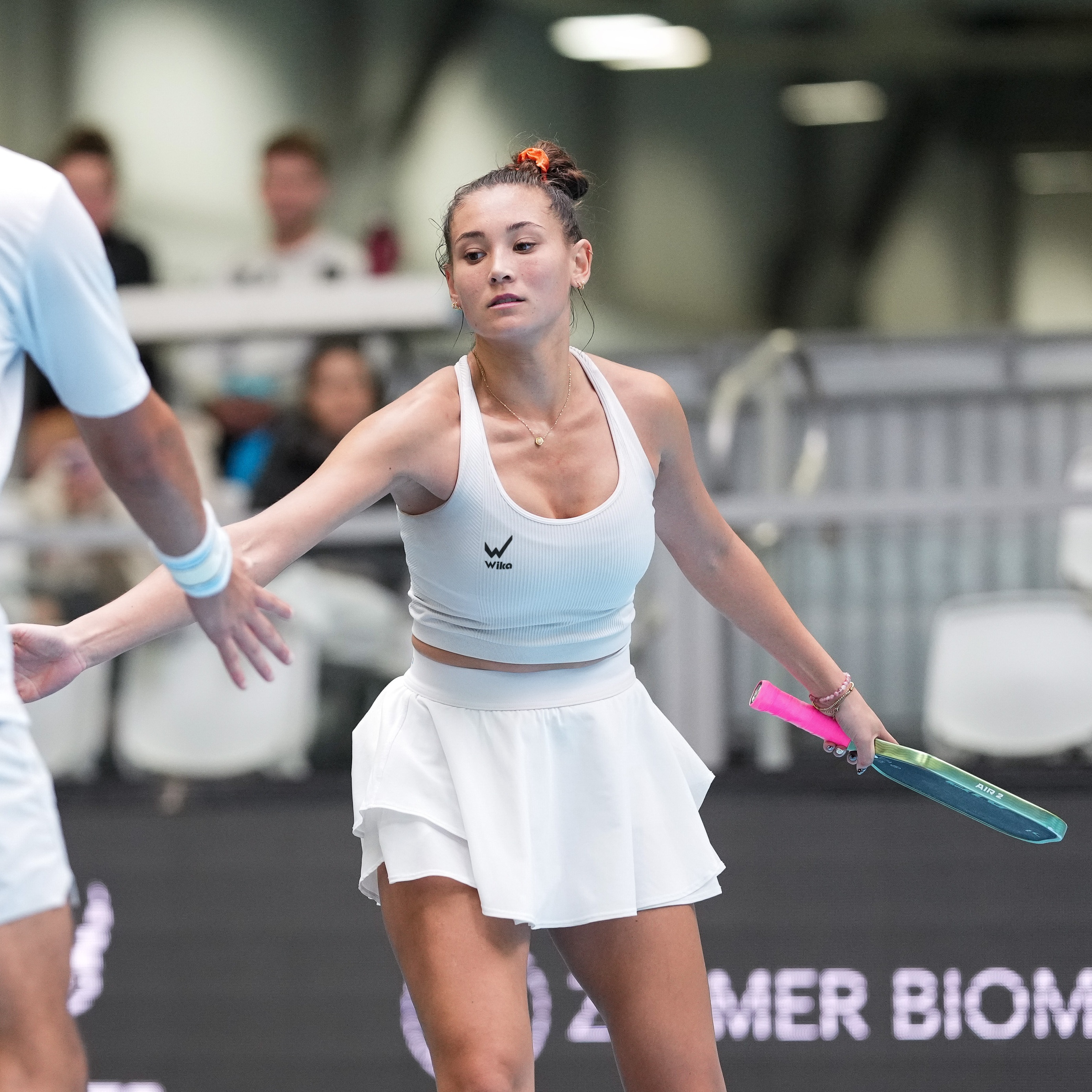 Roos Van Reek greeting her partner with a hand slap in Wika apparel