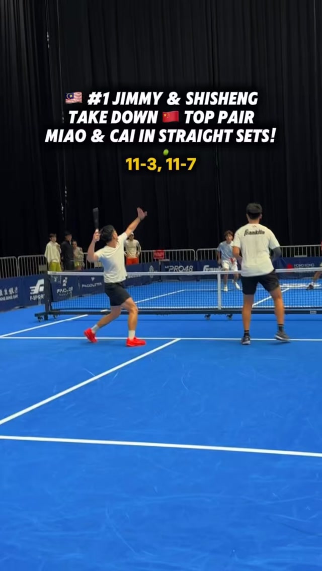 Malaysian pair in action on a blue court, with a graphic reading #1 Jimmy and Shisheng take down China's top pair Miao and Cai in straight sets, 11-3, 11-7