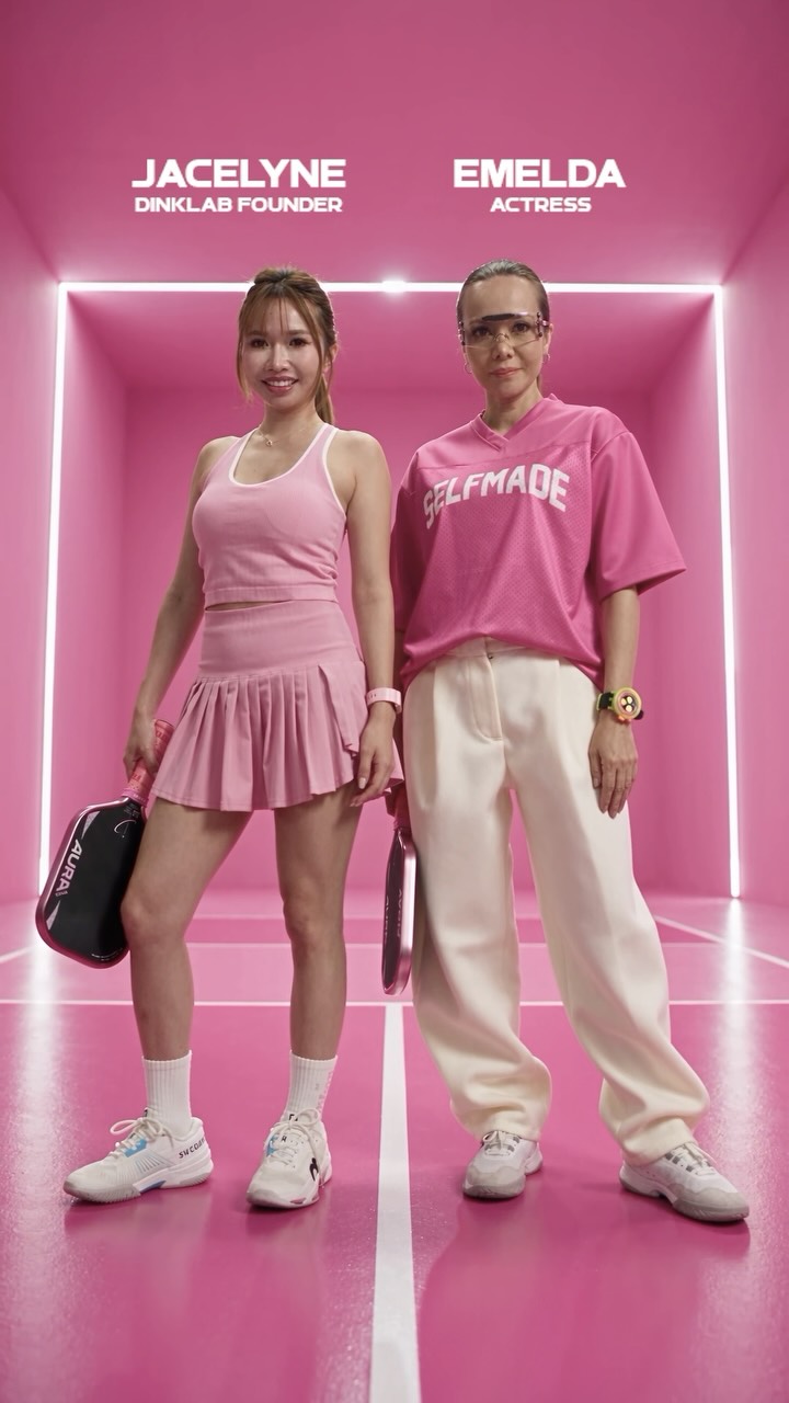 Jacelyne, Dinklab founder, and Emelda, actress, standing in pink outfits in a pink-lit court.