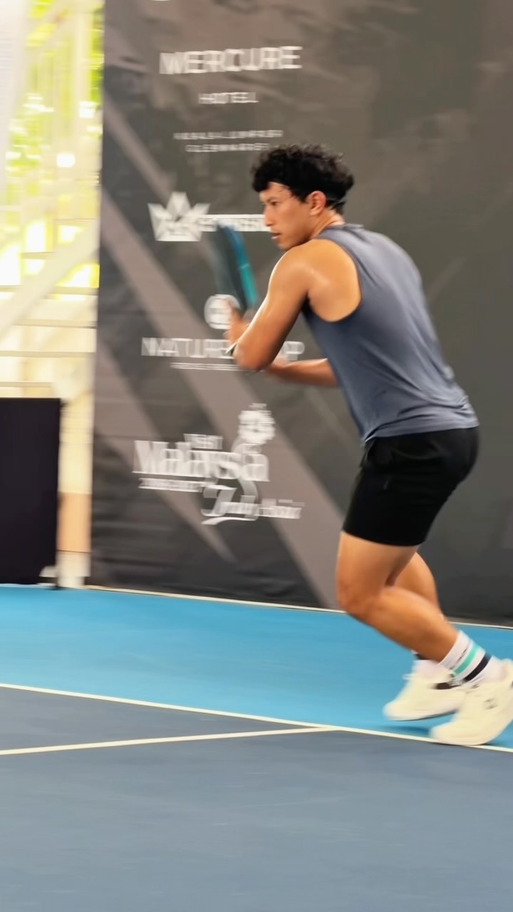 A player moving across the court during day one of the Paramount Cup 2026, with sponsor banners behind