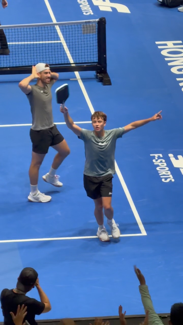 Federico Staksrud and Hayden Patriquin celebrate on the blue show court after winning the Hong Kong Slam men's doubles final